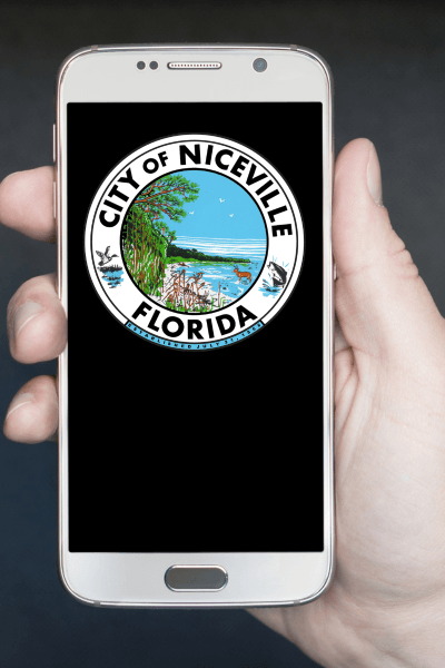 Hand holding a mobile device displaying City of Niceville seal