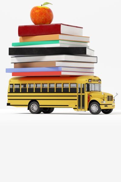 Toy school bus with books and an apple stacked on top